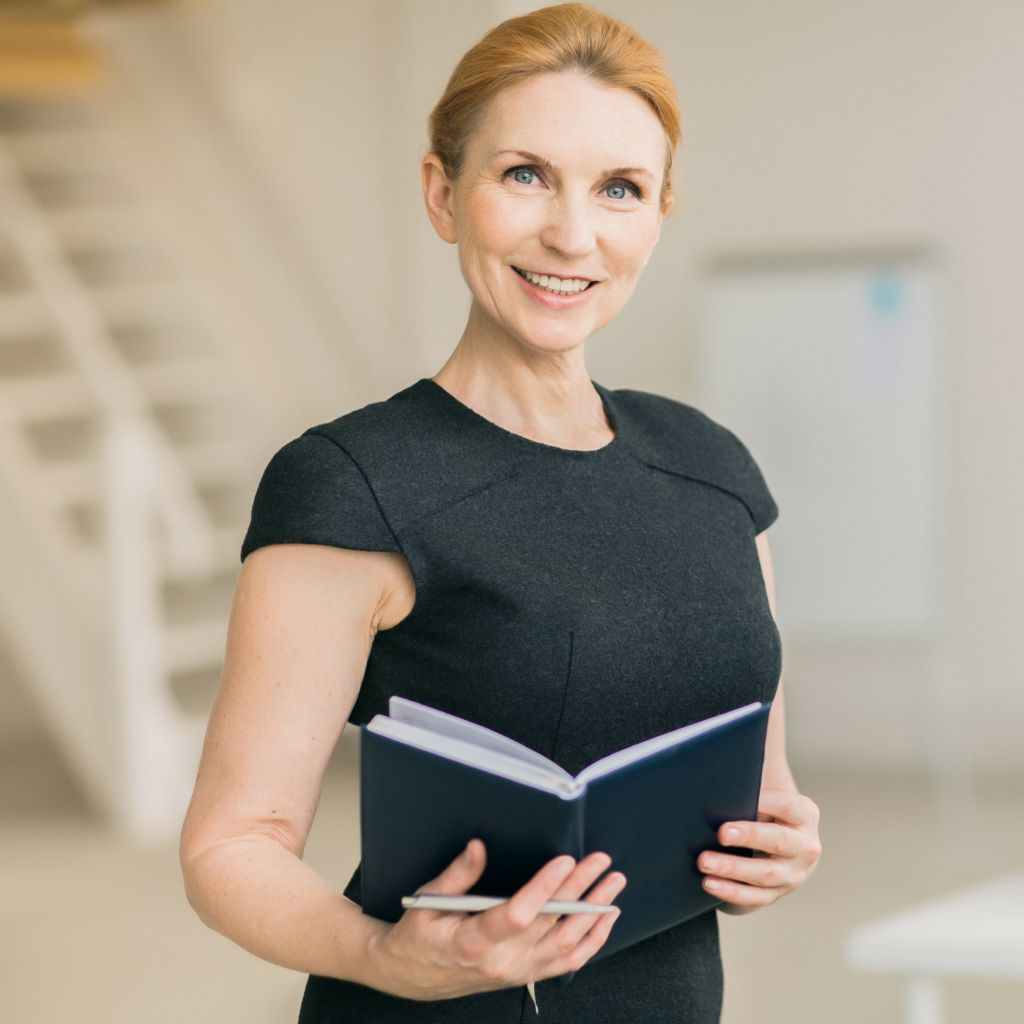 Business woman holding a book.